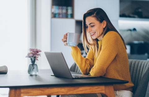 Smiling investor looking at laptop
